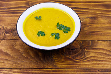 Pumpkin soup on a wooden table