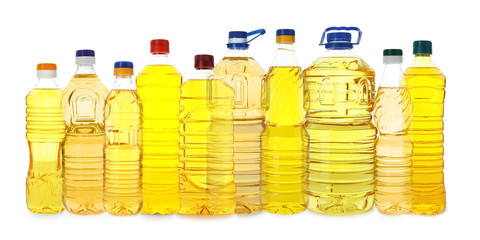 Plastic bottles with cooking oil on white background