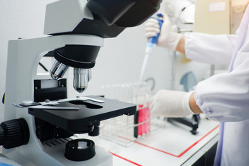 Cropped shot view of  the equipment and science experiments in Laboratory, Chemical substances for research and analyzing a sample under the microscope in laboratory.   