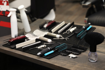 Naklejka premium Hairdresser tools on table in barber shop