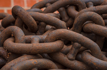 Rusty anchor chain close-up on a brick wall background