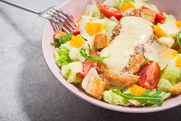 Fresh colored salad ceasar with metal fork