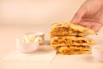 Hand picking slice of Butter Chicken Stuffed Naan