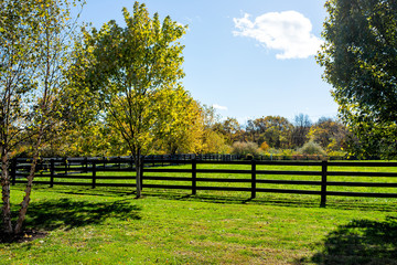 Fence for horses pasture on farm estate grounds in Virginia countryside in Frederick county during...