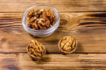Cores of walnut in glass bowl on a wooden table