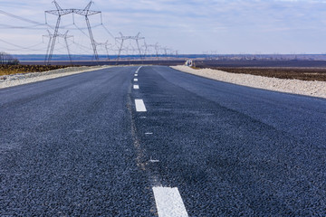 New asphalt road with the white dividing strip