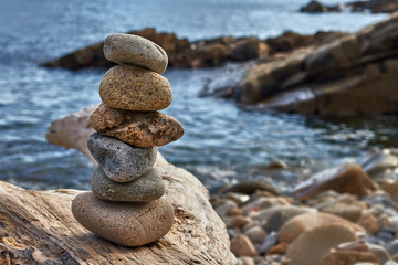 Fototapeta na wymiar Six stones in balance by the sea
