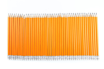 Close up view of a bunch of yellow pencils isolated on a white background. - Image