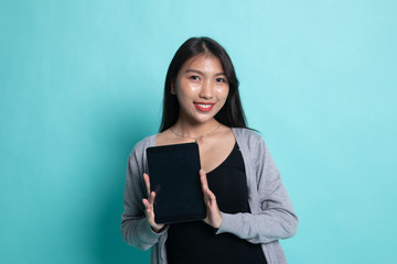 Young Asian woman with a computer tablet.