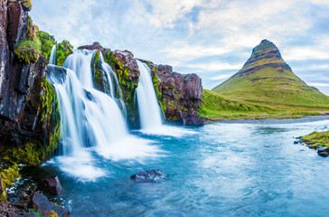 Beautiful natural magical scenery with a waterfall Kirkjufell near the volcano in Iceland. Exotic...