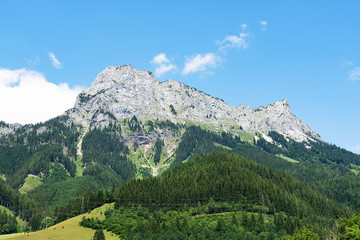 Panoramic view of the rocky peaks of the Alpine mountains against the sky. Landscape concept.