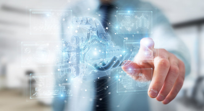 Businessman holding and touching wireframe holographic digital projection of an engine 3D rendering