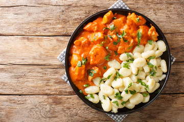 Hungarian Chicken Paprikash features tender braised chicken and a tangy sauce spiced with paprika closeup on a plate. Horizontal top view - obrazy, fototapety, plakaty