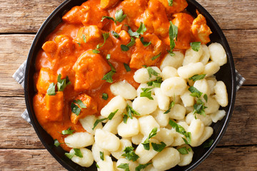classic Hungarian Chicken Paprikash recipe is comfort food closeup on a plate. Horizontal top view