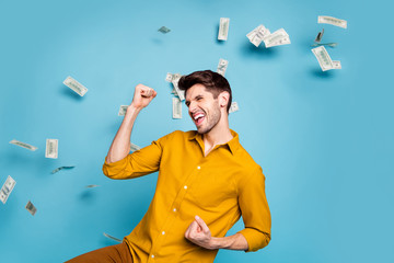 Photo of excited ecstatic crazy shouting manager having received salary payment wearing yellow...