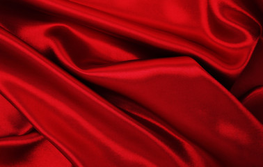 Smooth elegant red silk or satin luxury cloth texture as abstract background. Luxurious valentines day background design