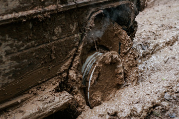 close of view of a very muddy wheel after off road driving through the dirt and mud.