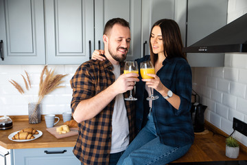 Attractive young guy and girl in the kitchen