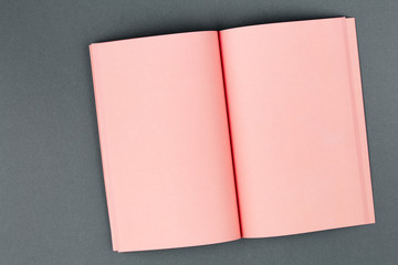 Pink notebook on two-tone gray background