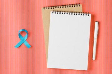 blue prostate ribbon on open notebook