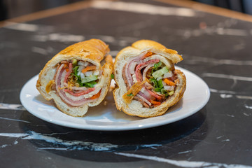 Plate of Vietnamese pork bacon sandwich- Banh Mi