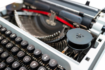 Classic, manual typewriter in white with a German keyboard layout, isolated on a white background with a clipping path.