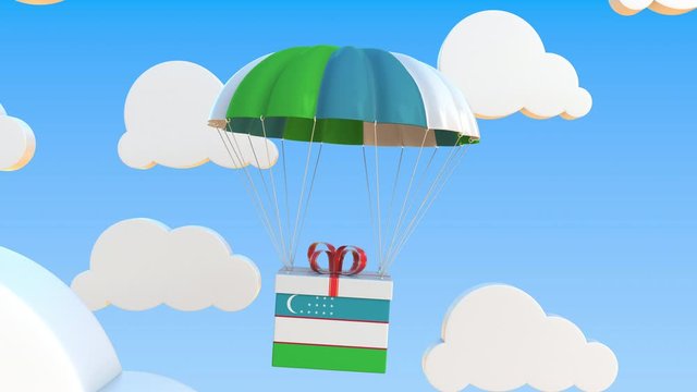 Box with national flag of Uzbekistan falls with a parachute. Loopable conceptual 3D animation