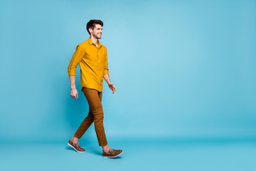 Fototapeta na wymiar Turned full length body size photo of attractive man going towards his workplace wearing shoes smiling toothily beaming isolated over blue pastel color background