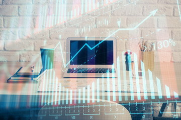 Financial market graph hologram and personal computer on background. Double exposure. Concept of forex.