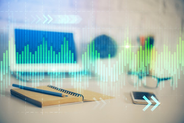 Stock market graph on background with desk and personal computer. Multi exposure. Concept of financial analysis.