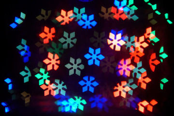 Snowflakes bokeh lights. Abstract christmas background with bright snowflakes