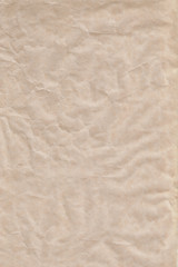 Empty sheet brown crumpled wrapping or parchment paper. Texture or background. Space for design or text. Soft focus. Top view.