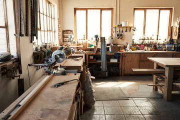 Assortment of tools on workbenches in a woodworking shop