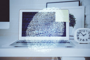 Computer on desktop in office with finger print drawing. Double exposure. Concept of business data security.
