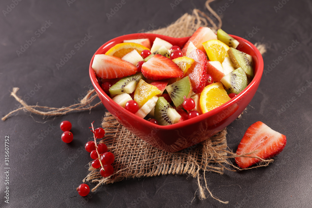 Poster fresh mixed fruit salad with berries, orange and banana