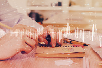 Multi exposure closeup hands with stock market forex graph.