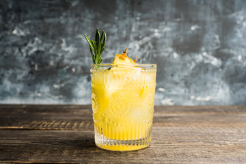 Old fahioned pineapple beverage on rustic background. Selective focus. Shallow depth of field.