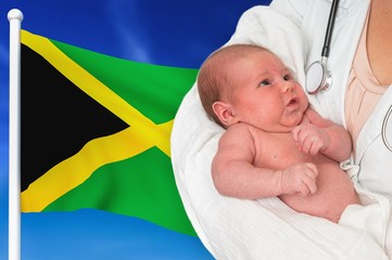 Birth rate in Jamaica. Newborn baby in hands of doctor.
