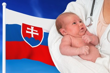 Birth rate in Slovakia. Newborn baby in hands of doctor.