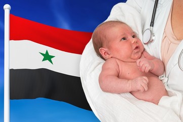 Birth rate in Syria. Newborn baby in hands of doctor.