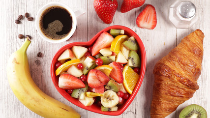 healthy breakfast with fruit, croissant and coffee cup
