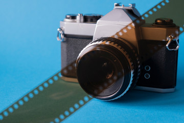 Film camera on a blue background, film for the camera