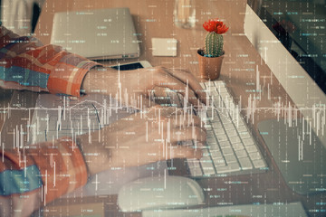 Double exposure of stock market chart with man working on computer on background. Concept of financial analysis.