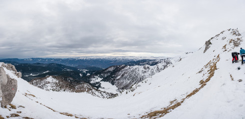 Spectacular winter mountain panoramic view of mountains with clouded sky.