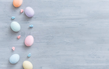 decorative easter eggs on a light wooden background. Easter-themed background with place for text