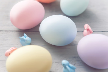 decorative easter eggs on a light wooden background. Easter-themed background with place for text
