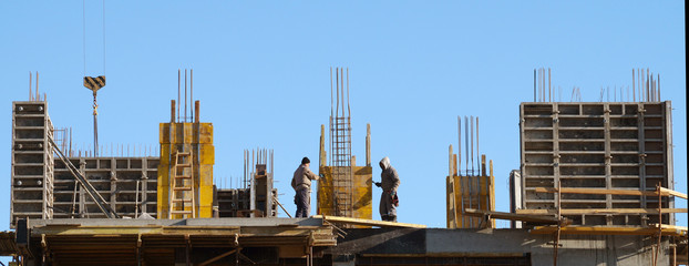 builders pour formwork on the construction of a monolithic house