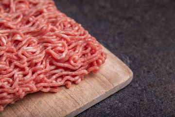 Minced Meat (Beef) as detailed close-up shot on dark background