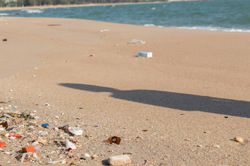 Plastic debris on the sand caused by human activities That is an environmental problem