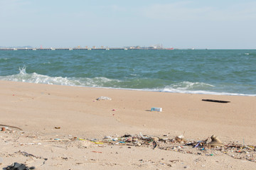 Plastic debris on the sand caused by human activities That is an environmental problem